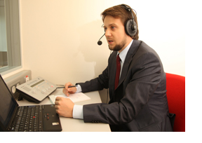 Dolmetscher, der vor seinem Laptop sitzt. (Foto: Gerhard Blank)